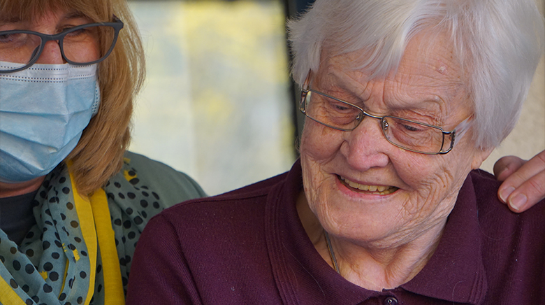 resident and carer standing together