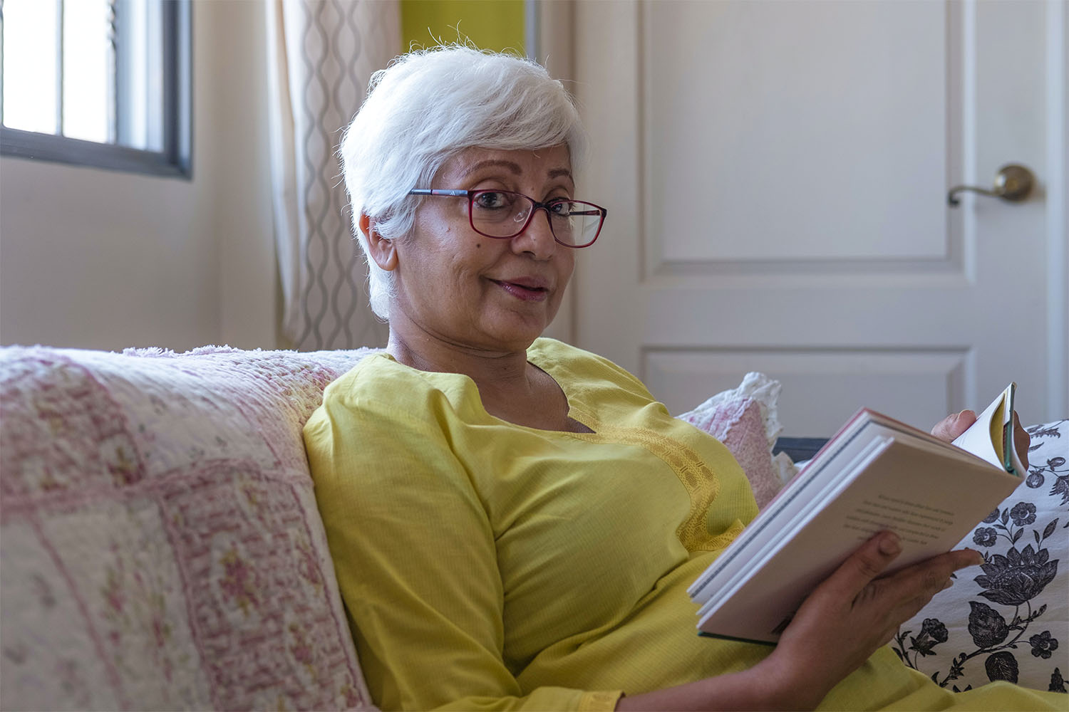 care home resident reading a book