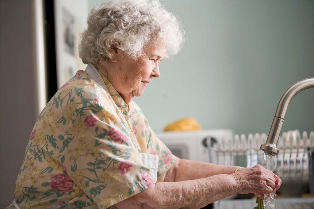 old lady washing dishes