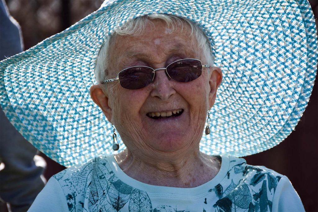 old lady with blue jumper and a blue hat